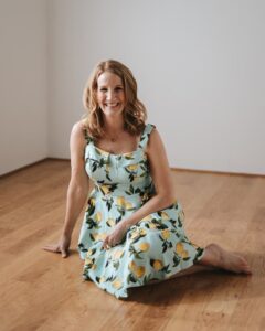 Julie Lemon sitting on the floor in a lemon dress